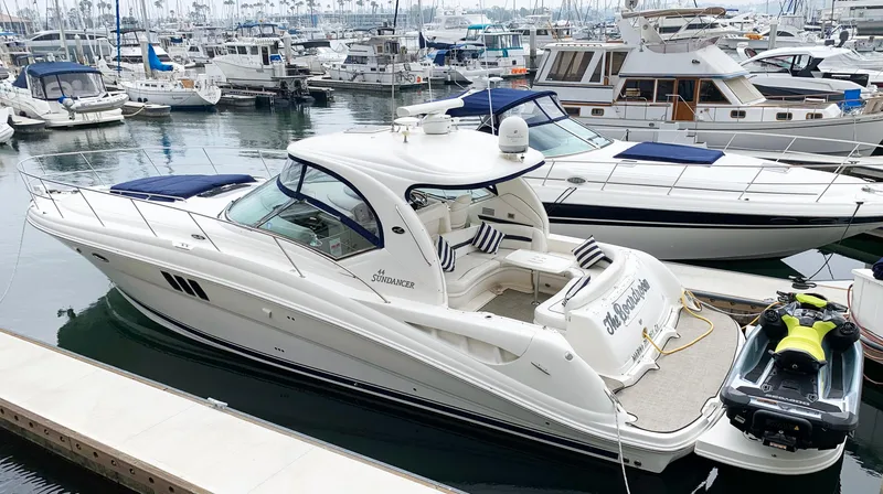 Slide: The Image of 2008 Sea Ray Sundancer yacht docked at marina, surrounded by other boats. - 44