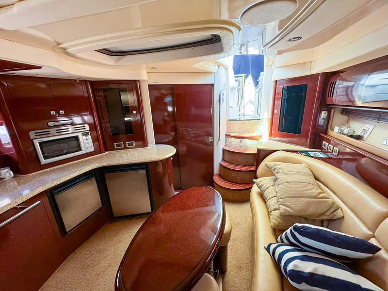 Slide: The Image of Luxurious 2008 Sea Ray Sundancer yacht interior with kitchen, seating, and elegant wood finishes. - 6