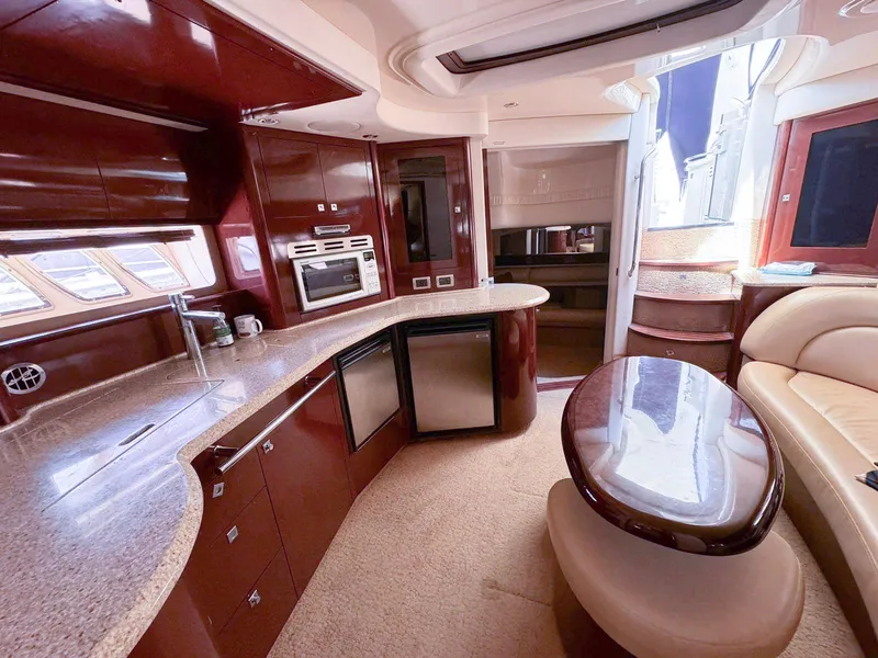 Slide: The Image of Luxurious 2008 Sea Ray Sundancer yacht interior with modern kitchen and elegant seating area. - 8