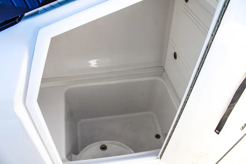 Slide: The Image of Spacious storage compartment in 2026 Invicta 320 CC boat, featuring sleek white interior design. - 11