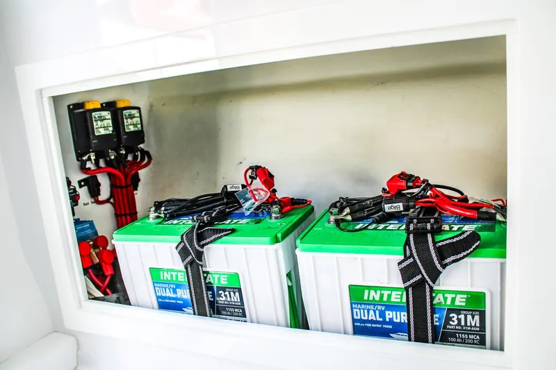 Slide: The Image of Battery compartment of 2026 Invicta 320 CC boat with dual-purpose marine batteries. - 13