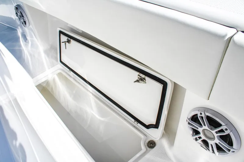 Slide: The Image of 2026 Invicta 320 CC boat storage compartment with speakers, showcasing sleek design. - 15