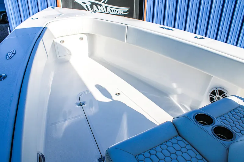 Slide: The Image of 2026 Invicta 320 CC boat interior with seating and cup holders, showcasing modern design. - 16