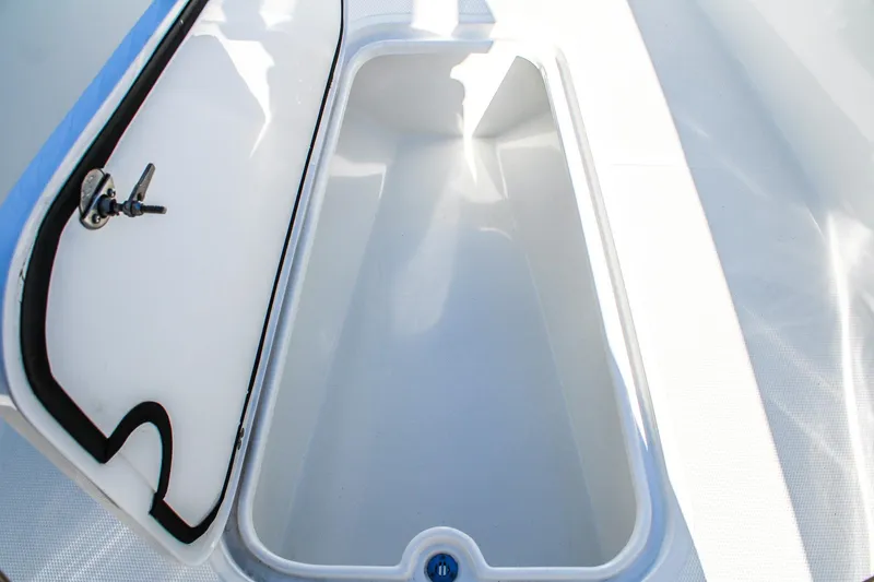 Slide: The Image of Open storage compartment on 2026 Invicta 320 CC boat, showcasing interior space. - 17