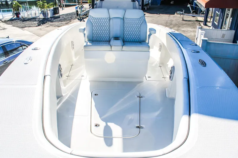 Slide: The Image of 2026 Invicta 320 CC boat interior with white seating and spacious deck. - 18