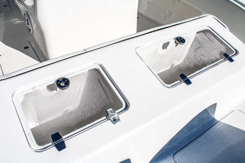 Slide: The Image of Invicta 320 CC 2026 boat with dual storage compartments on deck. - 3
