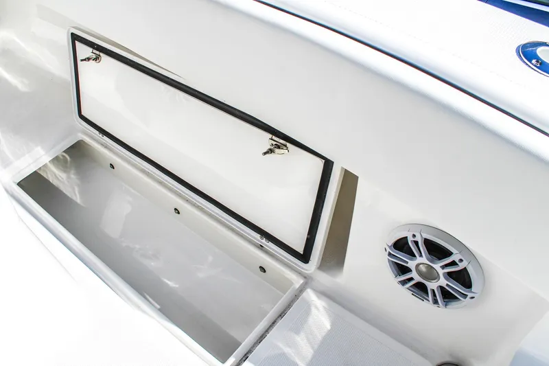 Slide: The Image of Open storage compartment and speaker on 2026 Invicta 320 CC boat. - 5
