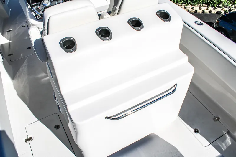 Slide: The Image of 2026 Invicta 320 CC boat interior with rod holders and sleek design. - 6