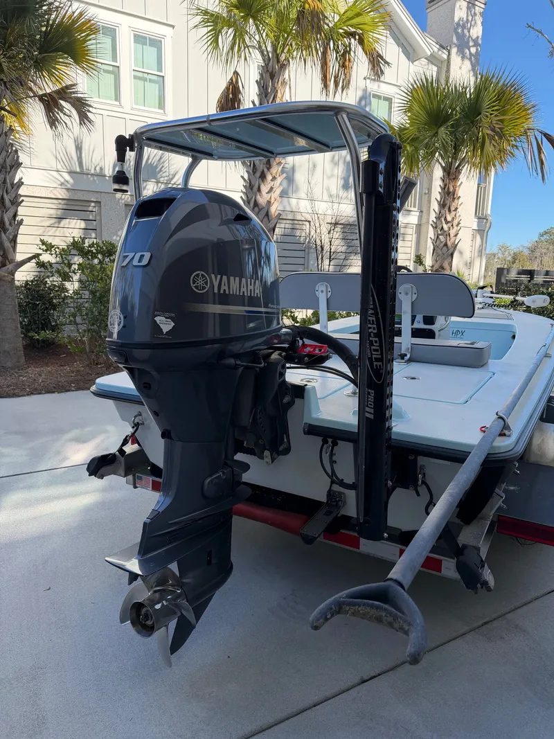 Slide: The Image of 2021 Maverick 17 HPX-S boat with Yamaha engine, palm trees in background. - 29