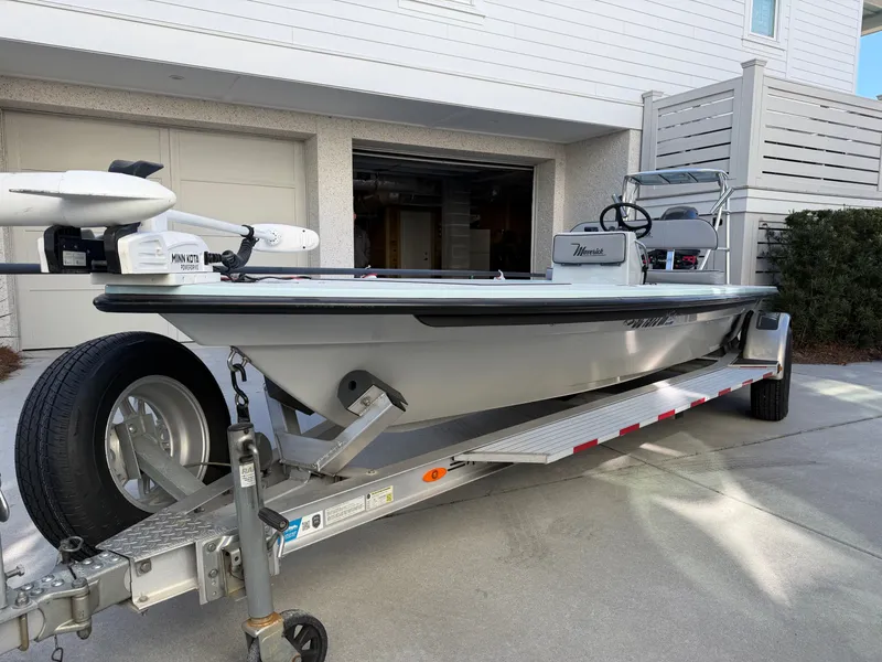 Slide: The Image of 2021 Maverick 17 HPX-S boat on trailer in front of garage. - 6