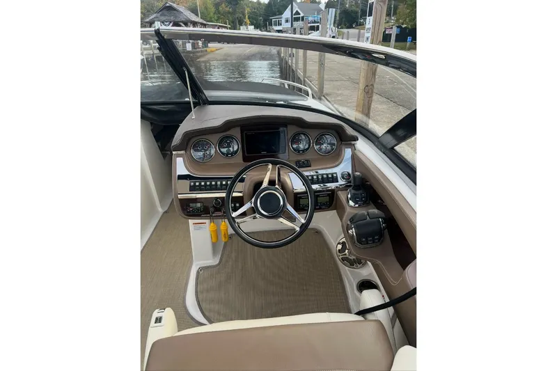 Slide: The Image of 2014 Chaparral 307 SSX boat dashboard with steering wheel and control panel. - 4