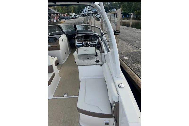 Slide: The Image of 2014 Chaparral 307 SSX boat interior with helm and seating area. - 8