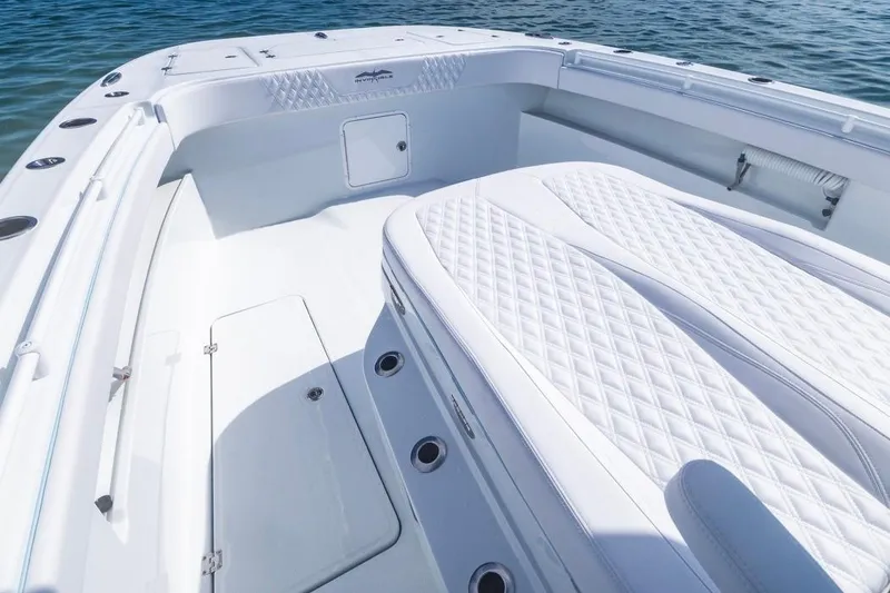 Slide: The Image of 2026 Invincible 33 Catamaran with luxurious white seating and spacious deck on the water. - 11