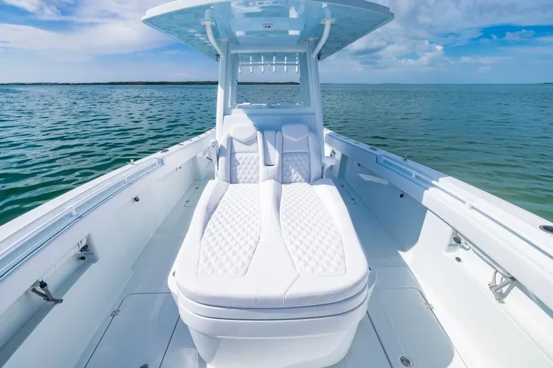 Slide: The Image of 2026 Invincible 33 Catamaran with luxurious seating on open water. - 12