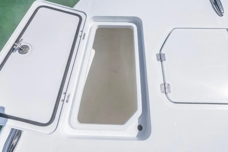 Slide: The Image of Open storage compartment on 2026 Invincible 33 Catamaran deck. - 15