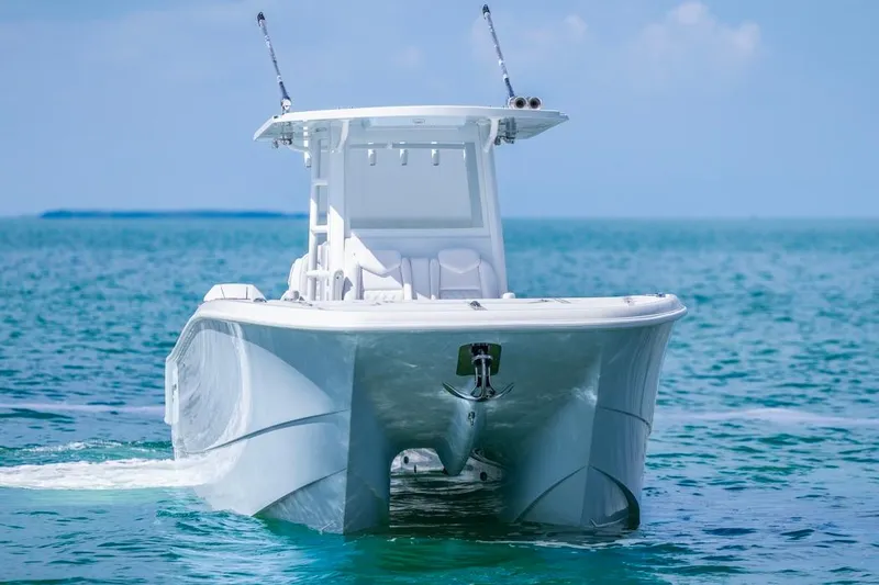 Slide: The Image of 2026 Invincible 33 Catamaran cruising on clear blue ocean waters. - 3