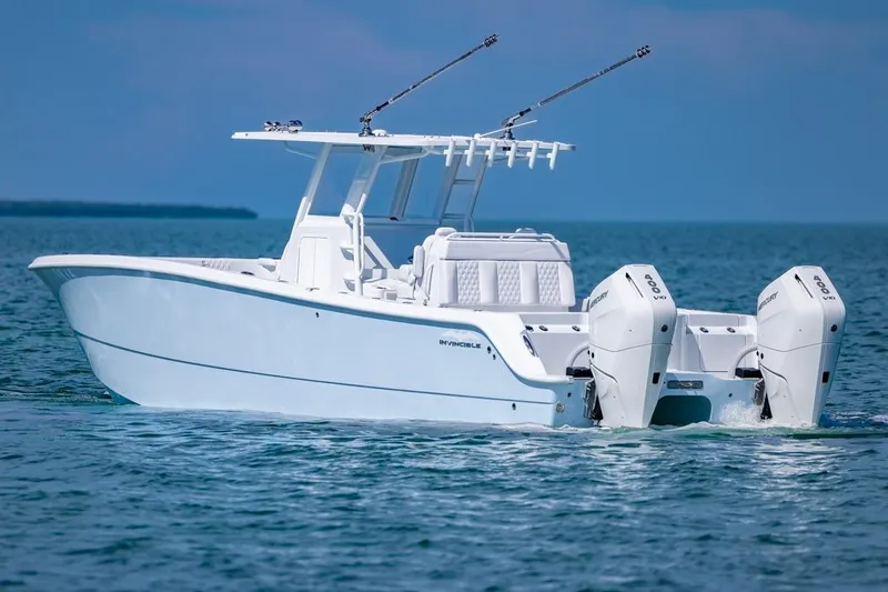 Slide: The Image of 2026 Invincible 33 Catamaran cruising on open water, showcasing sleek design and powerful engines. - 4