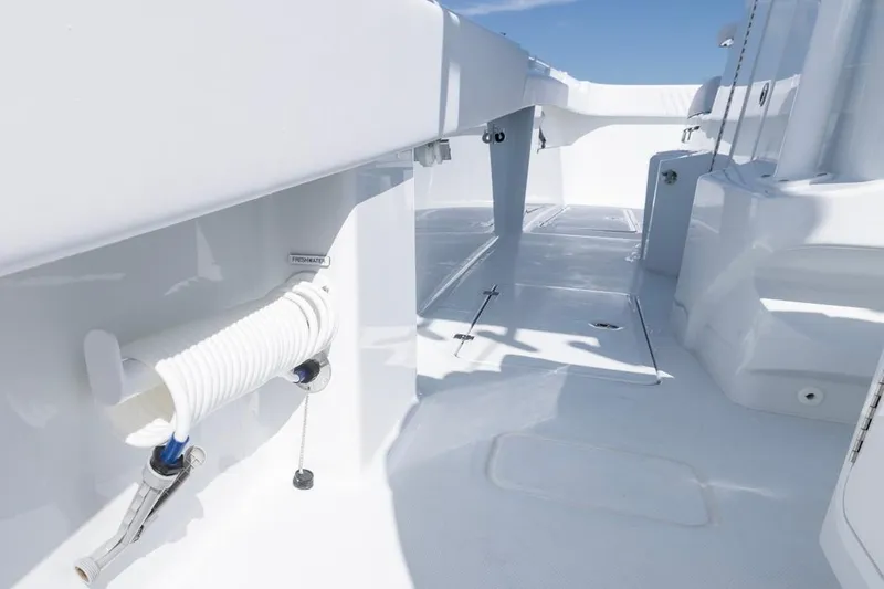 Slide: The Image of 2026 Invincible 33 Catamaran deck with freshwater hose, sleek white design. - 41