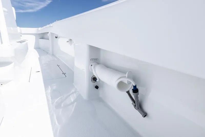 Slide: The Image of 2026 Invincible 33 Catamaran deck with coiled hose and sleek white finish. - 42