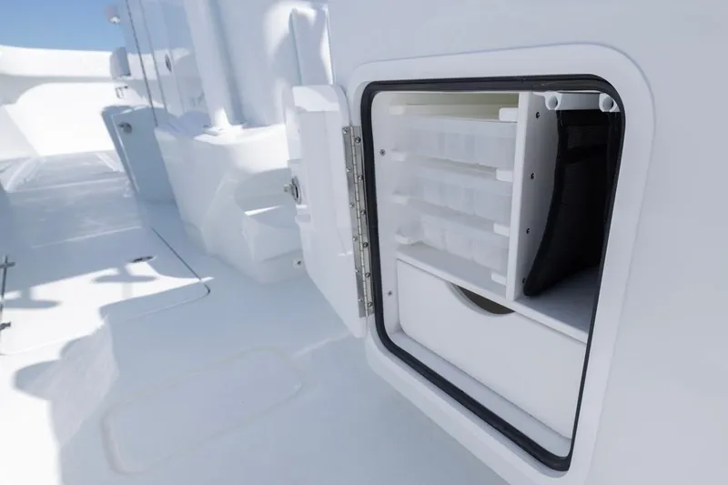 Slide: The Image of Open storage compartment on 2026 Invincible 33 Catamaran, showcasing organized interior space. - 43