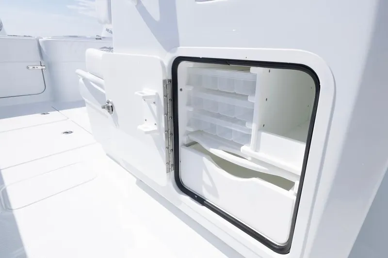 Slide: The Image of Open storage compartment on 2026 Invincible 33 Catamaran, showcasing interior shelving. - 44