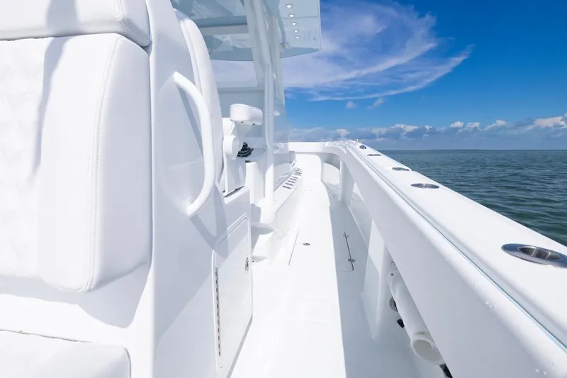 Slide: The Image of 2026 Invincible 33 Catamaran on open water, showcasing sleek white design and clear blue skies. - 45
