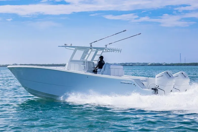 Slide: The Image of 2026 Invincible 33 Catamaran cruising on open water, showcasing sleek design and powerful engines. - 7