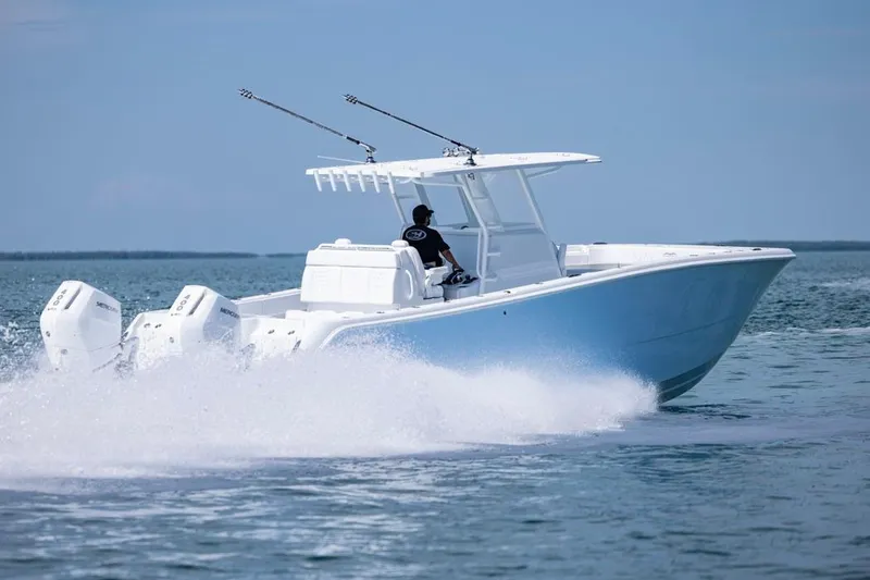 Slide: The Image of 2026 Invincible 33 Catamaran cruising on open water with dual outboard engines. - 9