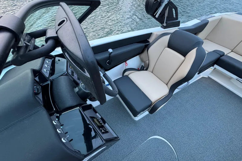 Slide: The Image of 2023 MasterCraft NXT22 boat interior with steering wheel and seating. - 14