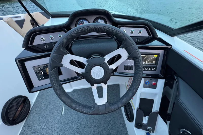 Slide: The Image of 2023 MasterCraft NXT22 boat dashboard with steering wheel and control panel. - 17
