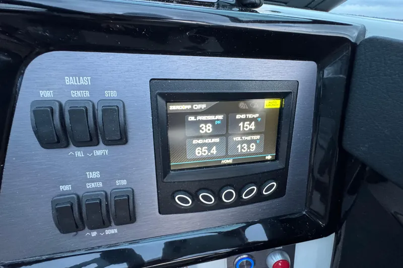 Slide: The Image of 2023 MasterCraft NXT22 dashboard with digital display and ballast controls. - 18