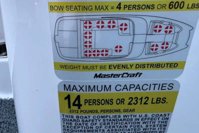 Slide: The Image of 2023 MasterCraft NXT22 capacity label: 14 persons or 2312 lbs, weight distribution required. - 21