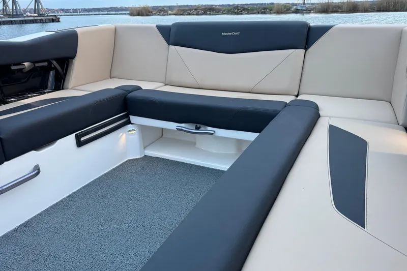 Slide: The Image of 2023 MasterCraft NXT22 boat interior with sleek seating and modern design. - 22