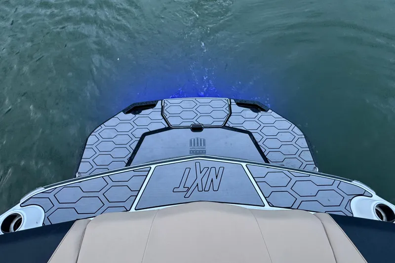 Slide: The Image of 2023 MasterCraft NXT22 boat platform with hexagonal design on water. - 25