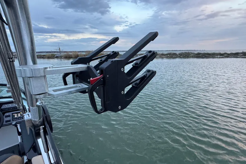 Slide: The Image of 2023 MasterCraft NXT22 boat with wakeboard rack on a calm lake. - 26