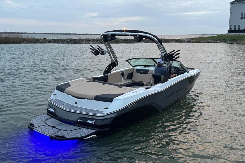 Slide: The Image of 2023 MasterCraft NXT22 boat on water with illuminated swim platform. - 5