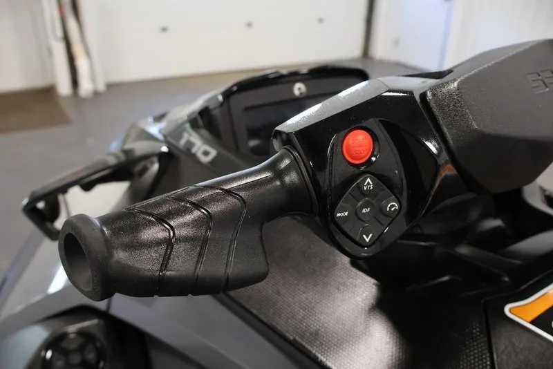 Slide: The Image of Close-up of 2026 Sea-Doo GTX 170 handlebar controls in a garage setting. - 6