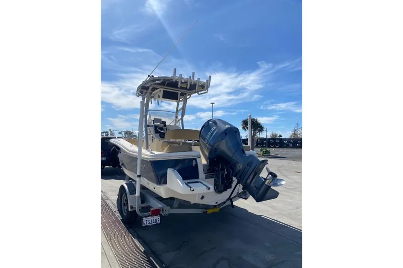 Slide: The Image of 2020 Scout 195 Sportfish boat with Yamaha outboard motor on trailer, under clear blue sky. - 11