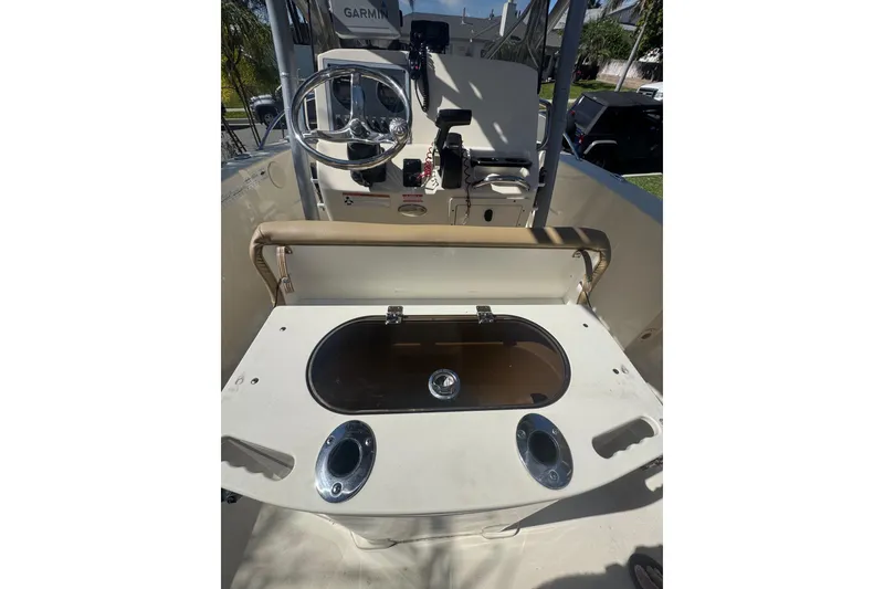 Slide: The Image of 2020 Scout 195 Sportfish boat interior with steering wheel and control panel. - 16