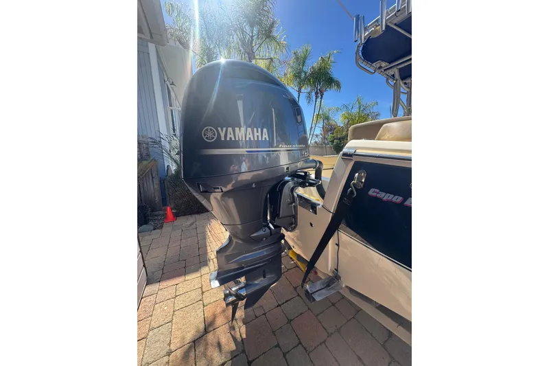 Slide: The Image of 2020 Scout 195 Sportfish with Yamaha outboard motor on a sunny day. - 18