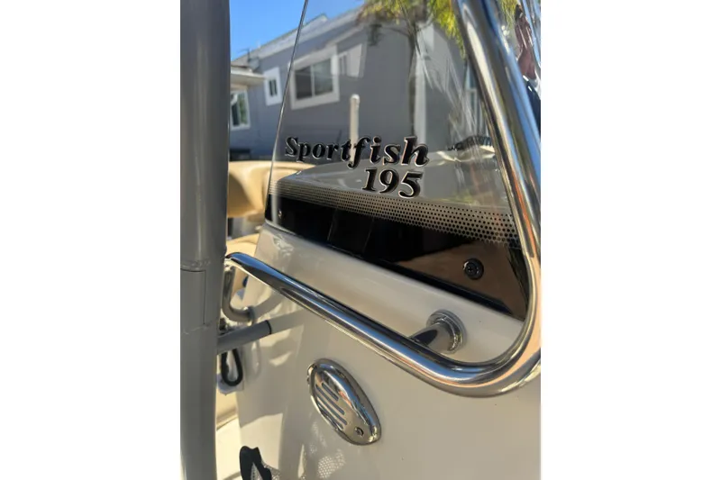 Slide: The Image of 2020 Scout 195 Sportfish boat console with chrome details and branding. - 21