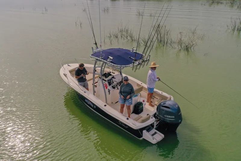 Slide: The Image of 2020 Scout 195 Sportfish boat with anglers fishing on calm waters. - 38