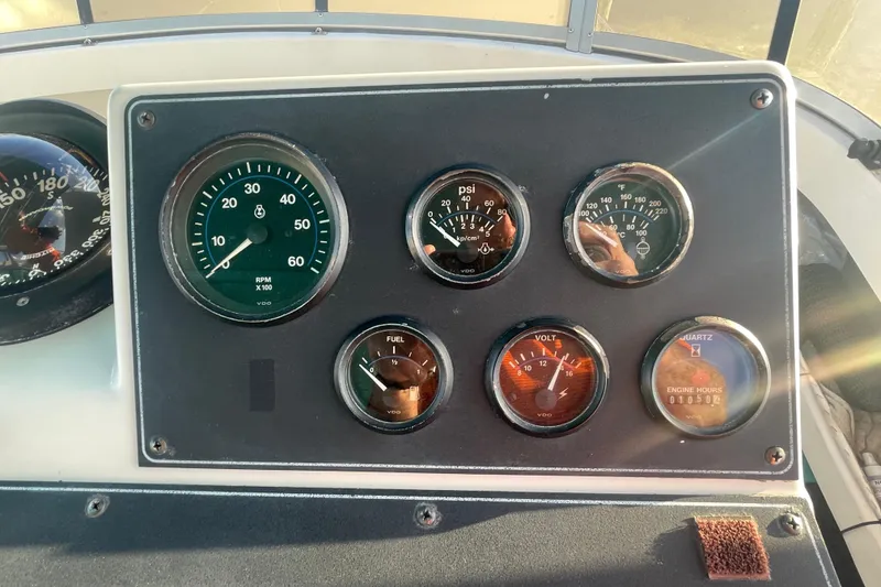 Slide: The Image of Dashboard of a 1995 Carver 355 Aft Cabin Motor Yacht with various gauges. - 10