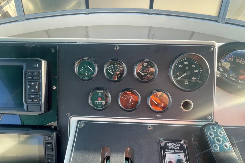 Slide: The Image of Control panel of a 1995 Carver 355 Aft Cabin Motor Yacht with gauges and controls. - 11