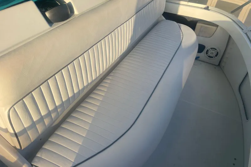 Slide: The Image of 1995 Carver 355 Aft Cabin Motor Yacht interior seating area with white upholstery. - 14