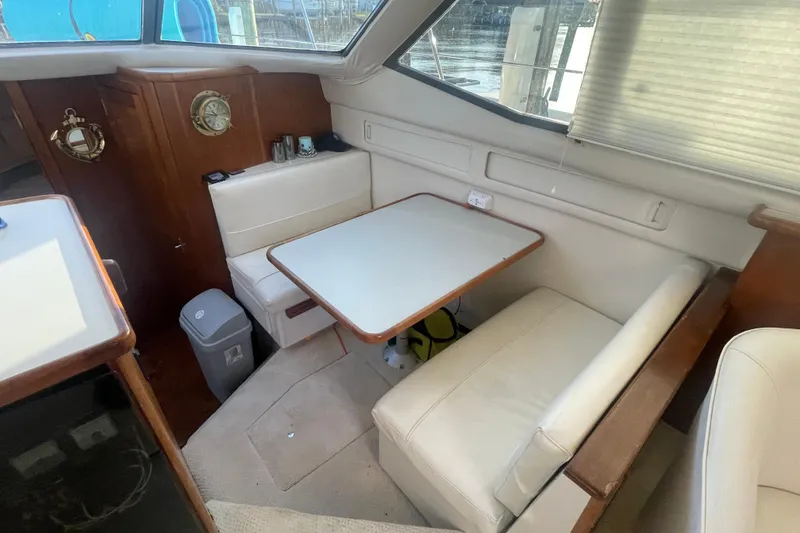 Slide: The Image of 1995 Carver 355 Aft Cabin Motor Yacht interior with dining area and seating. - 19