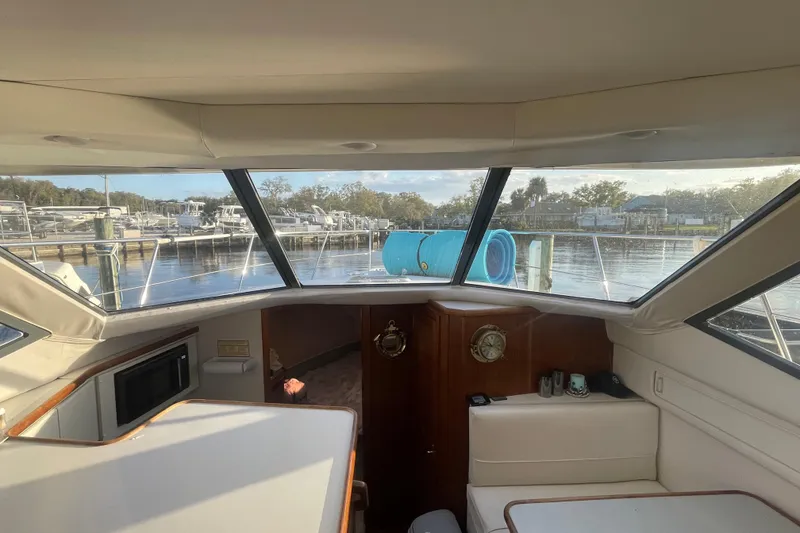 Slide: The Image of Interior view of 1995 Carver 355 Aft Cabin Motor Yacht with marina backdrop. - 21