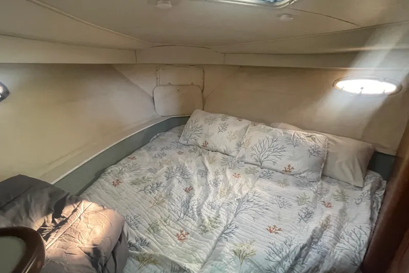 Slide: The Image of Cozy bedroom in 1995 Carver 355 Aft Cabin Motor Yacht with nautical-themed bedding. - 25