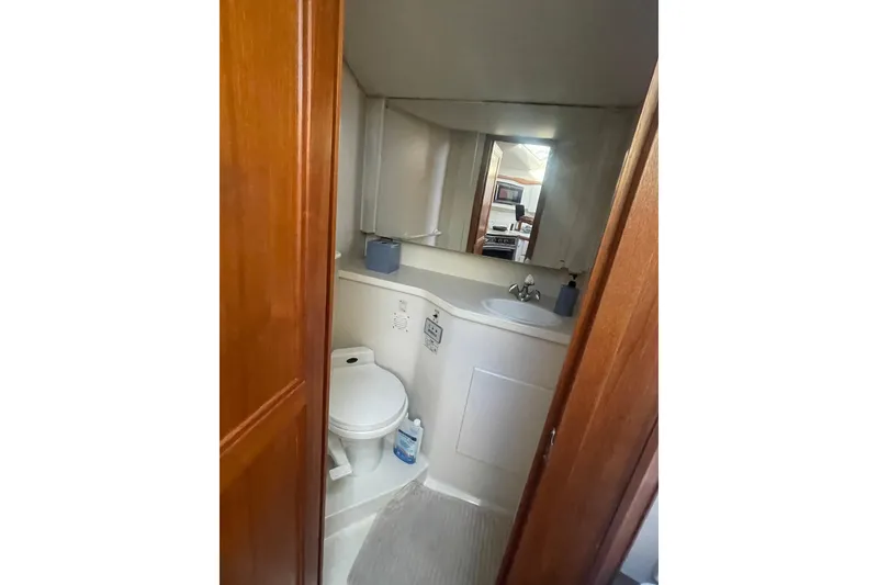 Slide: The Image of 1995 Carver 355 Aft Cabin Motor Yacht bathroom with sink, toilet, and mirror. - 26