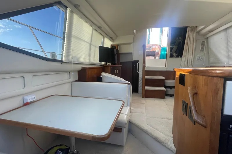 Slide: The Image of Interior of 1995 Carver 355 Aft Cabin Motor Yacht with dining area and stairs. - 27